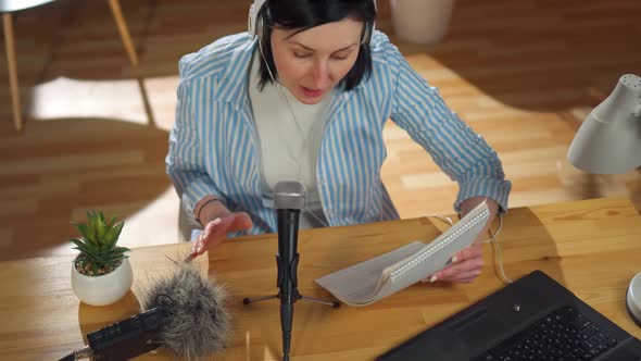 Woman Records a Podcast While Sitting in Her Living Roomtop View alt