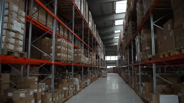 Rows of Racks with Cardboard Boxes in Warehouse alt