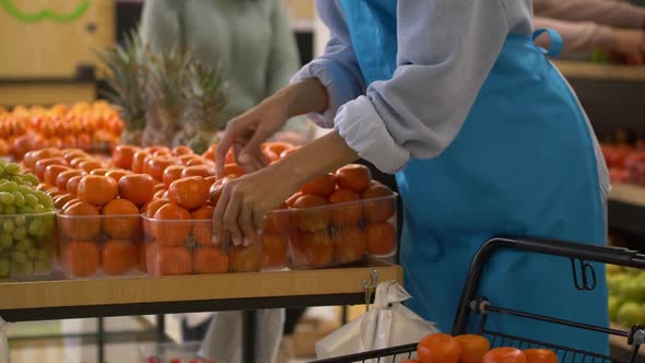 Hands of Female Supermarket Employee During Work alt