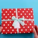 Hands Holding Gift Box Turquoise Blue Background - VideoHive Item for Sale