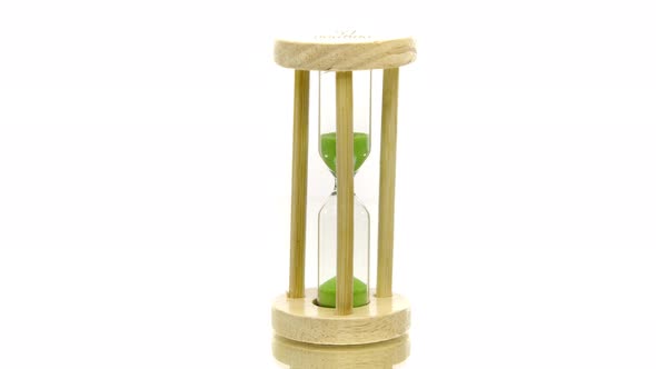 Green Sand Pouring in Hourglass Spinning 360 on White. Global Warming Deadline alt