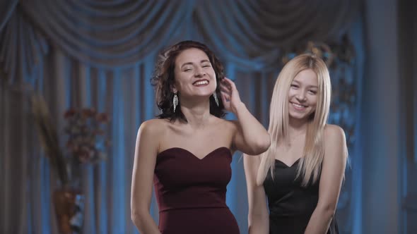 Beautiful Girls in Dresses Laughing at the Camera