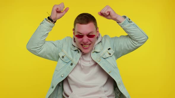 Crazy Man in Jacket with Hoodie Demonstrating Tongue Out Fooling Around Making Silly Faces Madness alt