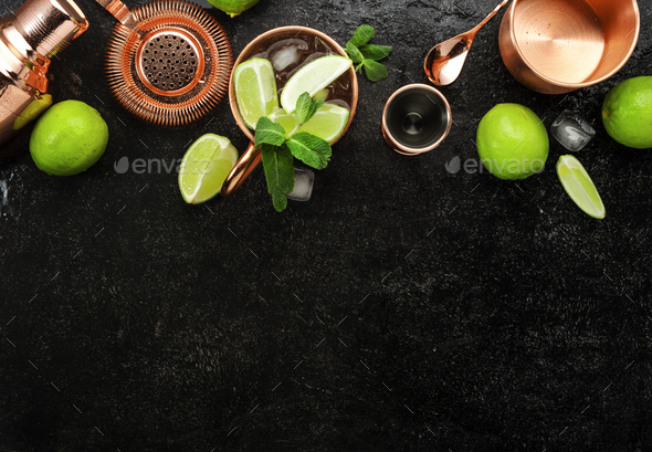 Moscow Mule. Preparation cocktail with ginger beer, vodka, lime and ice. Copper bar tools