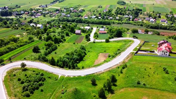 Aerial drone view of a flying over the rural agricultural landscape. alt