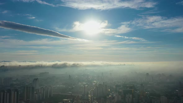 Fog morning at downtown district. Above the clouds. alt