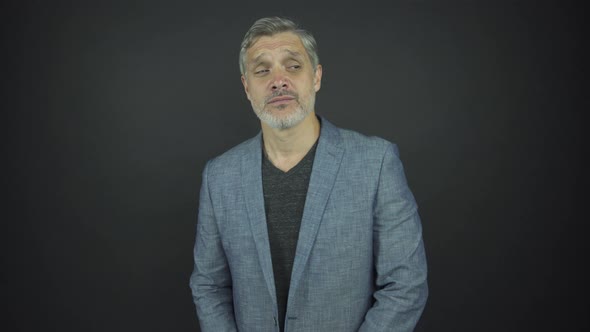 Handsome Actor with Grey Beard and Hair Looks Straight alt