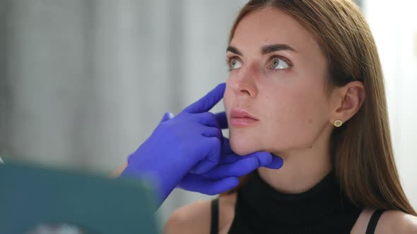 Closeup Young Woman Listening Carefully to Unrecognizable Beautician Sitting in Beauty Salon Looking alt