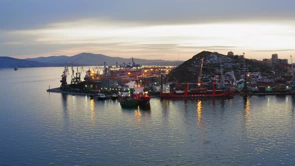 Drone View of the Cargo Terminal with Port Cranes at Sunset alt