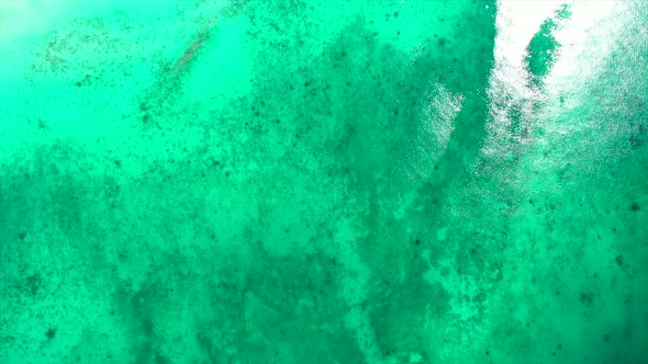 fly over shot of turquoise sea off Madagascar alt