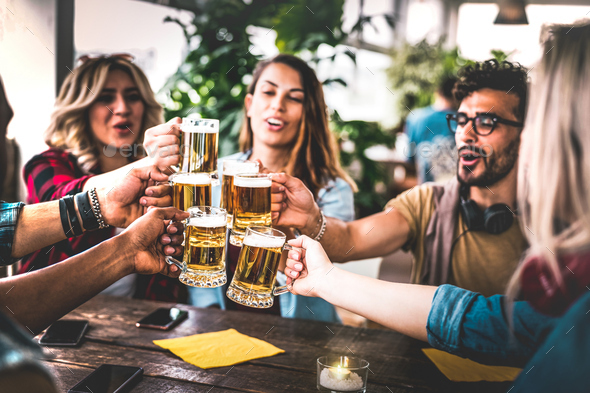 Friends toasting beer at brewery bar indoor at rooftop party Stock ...