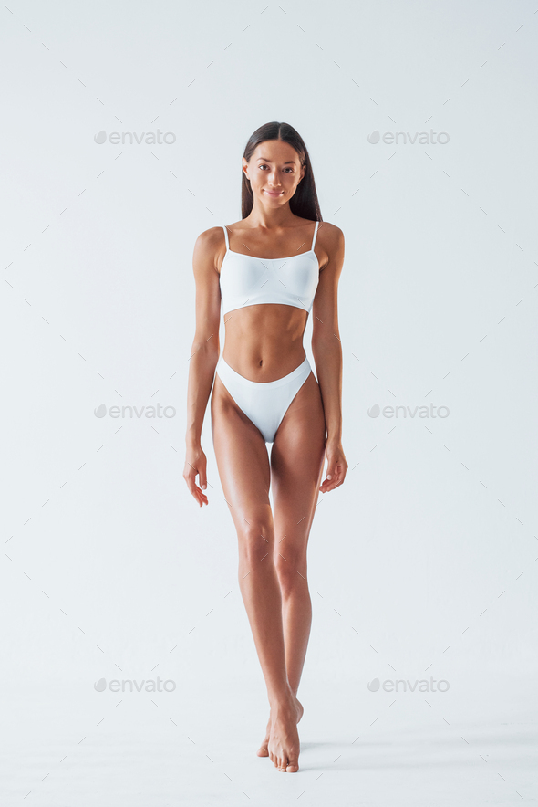 Beautiful woman with slim body in underwear is in the studio Stock
