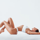 Side view of girl that lying down. Beautiful woman with slim body in  underwear is in the studio Stock Photo by mstandret
