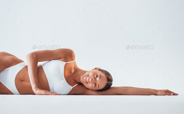 Beautiful woman with slim body in underwear is in the studio Stock Photo by  mstandret