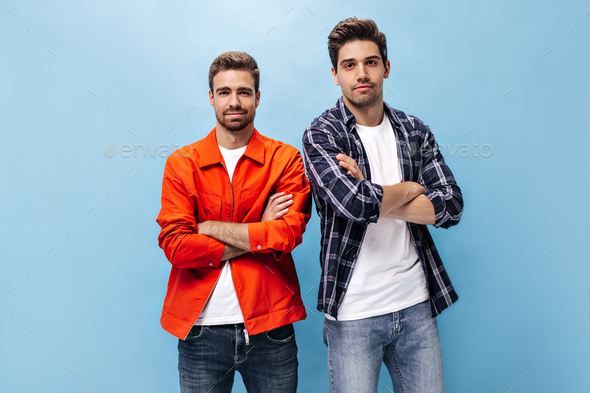 Two young men of Caucasian and African American appearance in sports  jackets pose against a dark background. Young men look at the camera  seriously. AI Generative 32720209 Stock Photo at Vecteezy