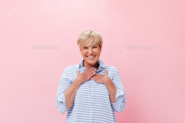 Lady in plaid shirt feels happiness on pink background