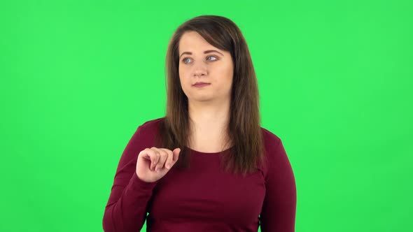 Portrait of Pretty Girl Talking About Something Pointing at Him, Copy Space. Green Screen alt