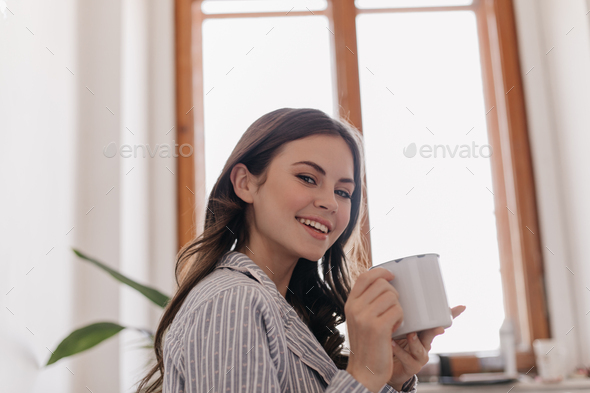 Free Photo | Close up shot of cheerful african american female listens  pleasant music with headphones, poses for selfie, being in good mood.  teenage dark skinned girl enteratins herself with modern device