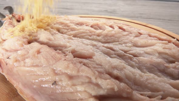 Closeup of a Mixture of Lemon Zest Salt and Sugar Falling on the Mackerel Fish alt