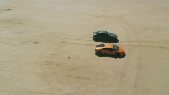 Racing Footage Aerial Around Modern Design Sport Cars Ready for Desert Racing alt