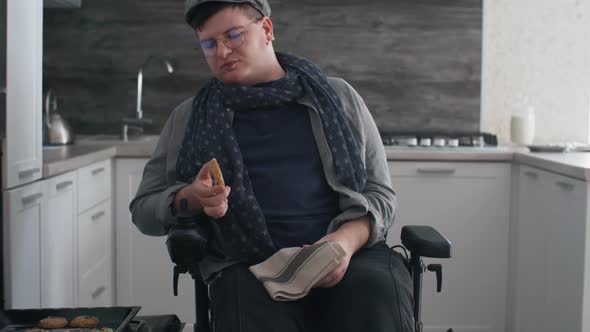 Man in Wheelchair Trying Homemade Cookies alt