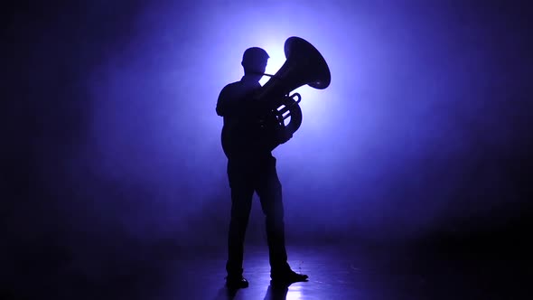 Trumpeter Man in Slow Motion Plays on Tuba, Smoky Studio alt