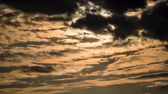 Time Lapse of Layered Orange Clouds Moves in the Sunset Sky alt