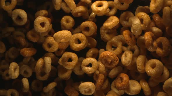 Round Breakfast Cereals Flying In The Air In Slow Motion On Black Background 4k alt