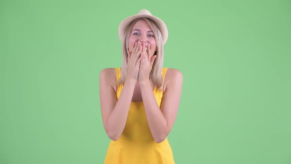Happy Young Blonde Tourist Woman Smiling and Laughing alt