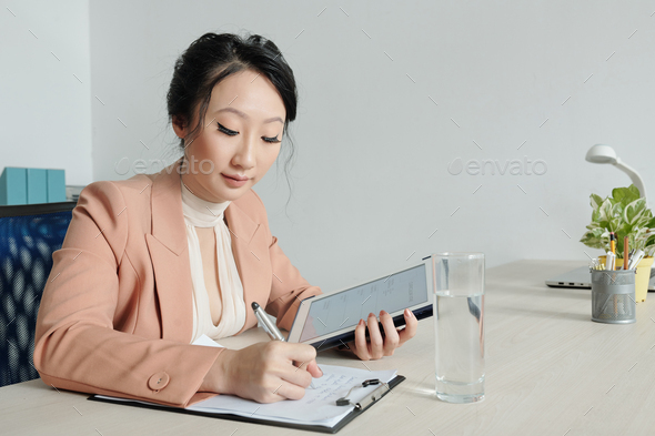 Young businesswoman filling cv form