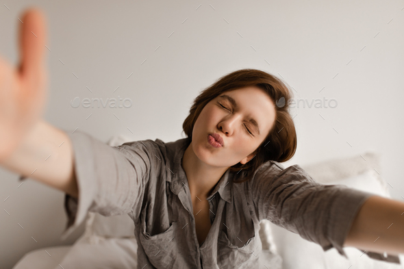 Relaxed young couple lying on bed, posing for selfie on smartphone Stock  Photo - Alamy
