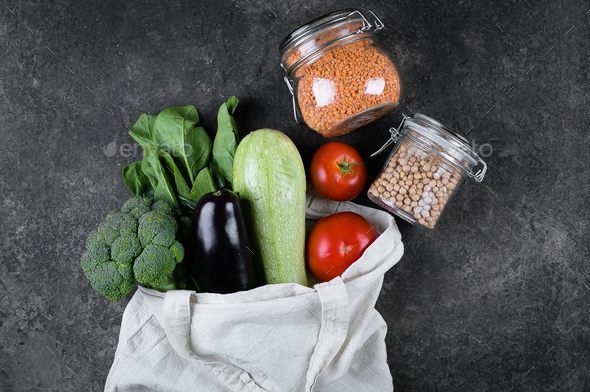 Zero waste concept. Female hands holding vegan vegetables in coton reusable bag