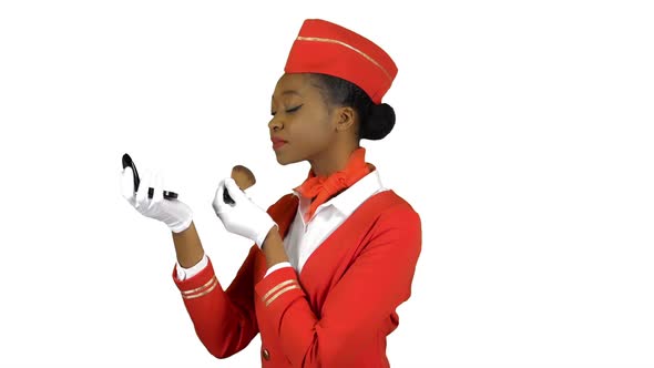 Stewardess Afro American Looks in the Mirror and Paints Her Face with Blushes. Alpha Channel alt