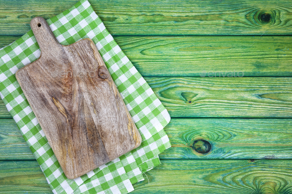 Cutting board on dark wood background, top view Stock Photo by xamtiw