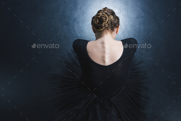 top view of elegant ballerina in leotard and black tutu in studio