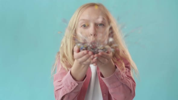 School Girl Blowing Sparkles off Hands alt