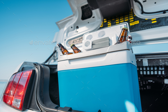 close up view of portable fridge with beer standing in car