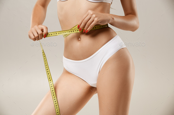 Woman with natural slim tanned body in underwear - Stock Photo - Images