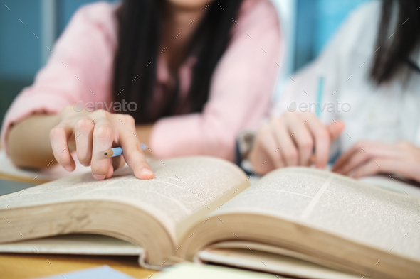 Young students campus helps friend catching up and learning. - Stock Photo - Images
