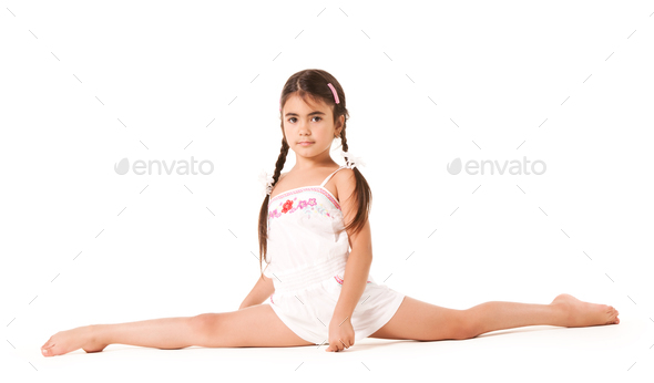 A little girl sits on a twine on a white background
