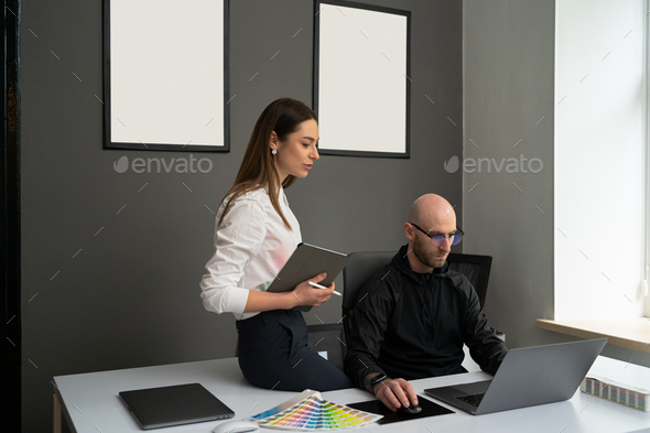 Two colleagues working concentrated at laptops in the office - Stock Photo - Images