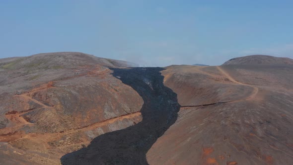 Aerial Drone Flying Forward to Fagradalsfjall Black Lava River Iceland Sunny Day alt