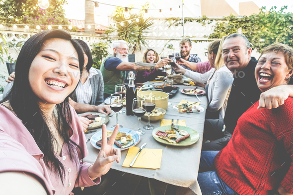 Happy family and friends taking selfie at barbecue dinner - Stock Photo - Images