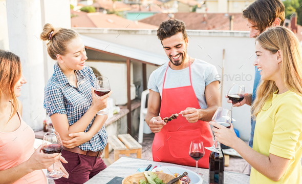 Happy friends having barbecue party on top of the roof - Stock Photo - Images