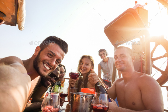 Group of happy friends taking selfie while drinking sangria in boat exclusive party - Stock Photo - Images