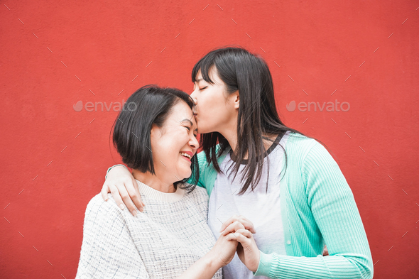 Asian mother and daughter having fun outdoor - Stock Photo - Images