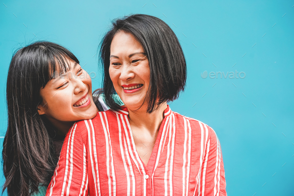 Asian mother and daughter having fun outdoor - Happy family people enjoying time togehter - Stock Photo - Images