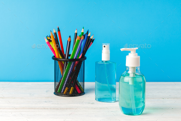 School supplies and hand sanitizer. Pandemic education concept