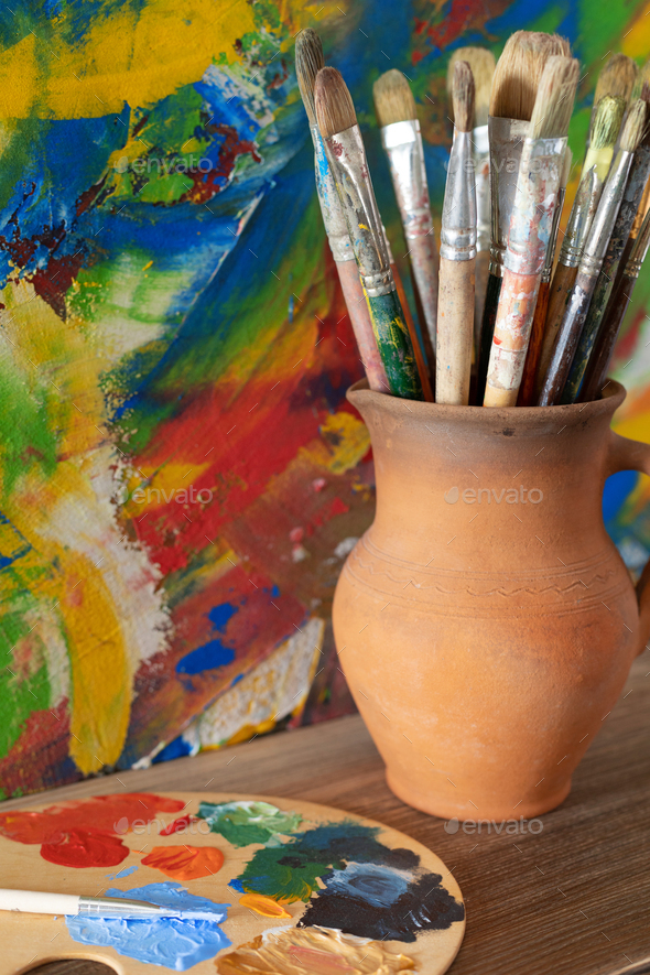 Paint brush and painters palette on table Stock Photo by ©seregam 11624373