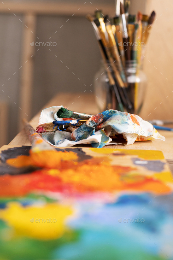 Painting palette and paint brush in glass jar on wooden table or  windowsill. Art still life Stock Photo by seregam